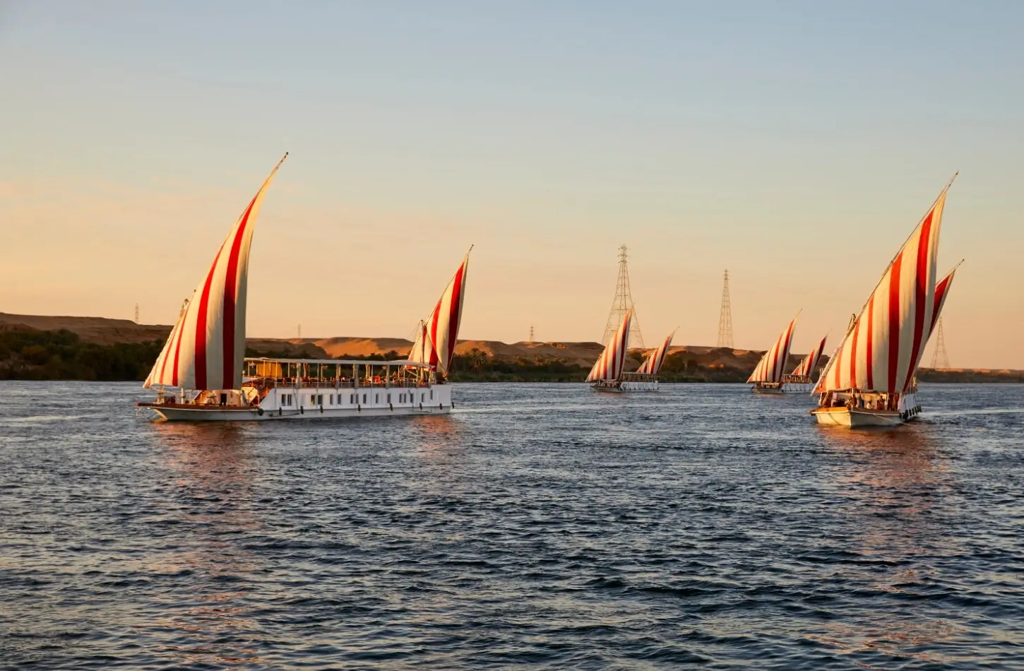 Feluccas and dahabiyas with red striped sails on the Nile