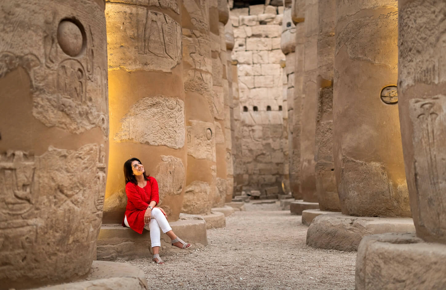 Tourist sitting inside the hypostyle hall