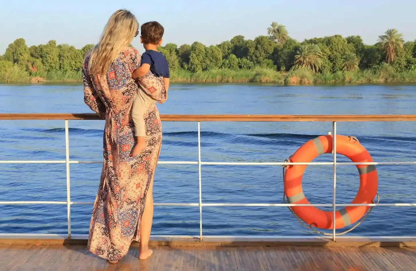 Mother holding her child on the deck of a Nile river cruise
